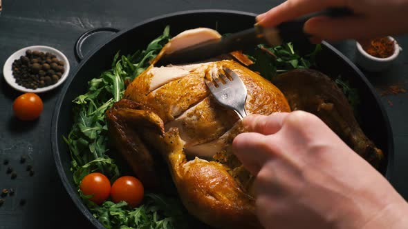 Fried Chicken or Turkey Cut By the Hands of a Person with Green Herbs in an Iron Dish