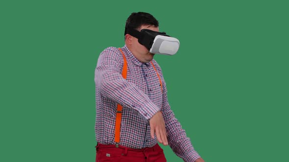 Portrait of a Dancing Man with a Virtual Reality Headset or 3d Glasses on His Head alt