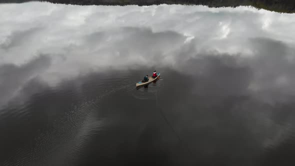 Tranquil Canoe Adventure On Lake with Reflection on Water Leisure Aerial