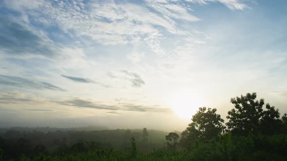 Fluffy fog cloud flowing on natural forest mountain from time lapse sunrise cloudy sky on morning alt