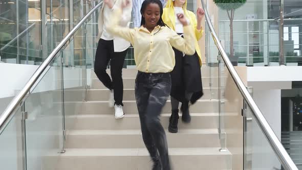 Happy Young People Students Dancing Down the Stairs