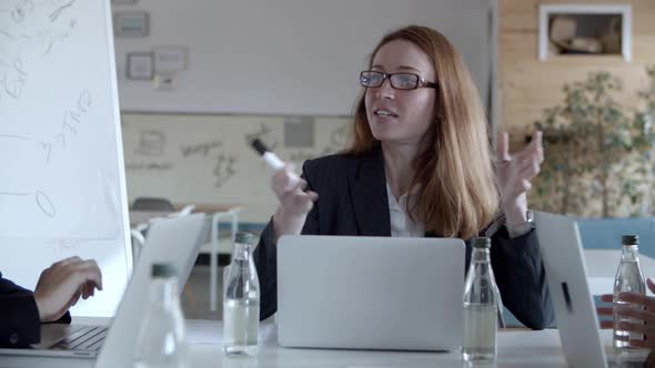 Smiling Businesswomen Discussing Project at Workplace alt