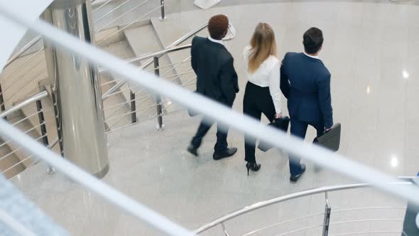 Group of business supervisors going through the hall