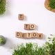 Woman's Hand Collects Text From Wooden Cubes Detox Time. Green Smoothie, Fruits And Herbs