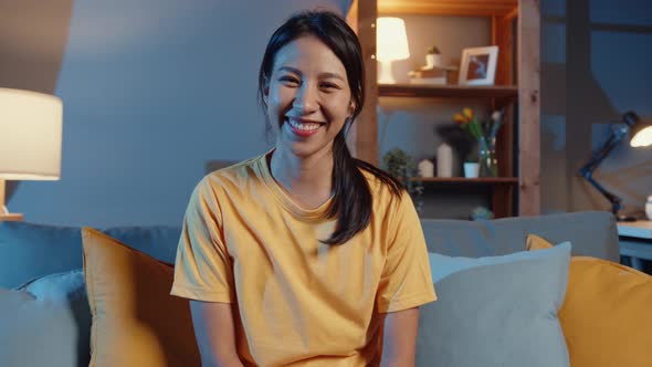 Happy young freelance asian woman looking at camera smiling and cheerful relax on video call.