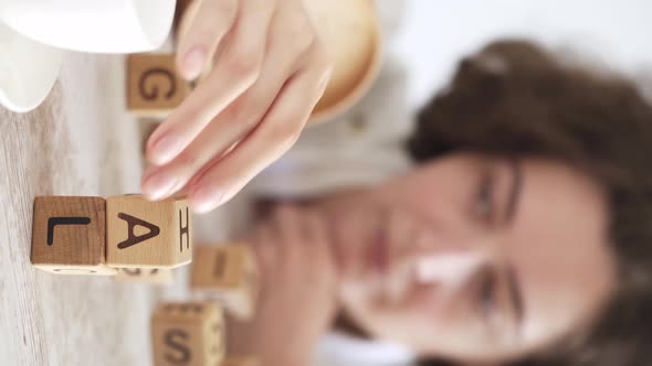Pursuit of goal. Goal achievement concept. Hand of young girl collects word goal from wooden cubes alt