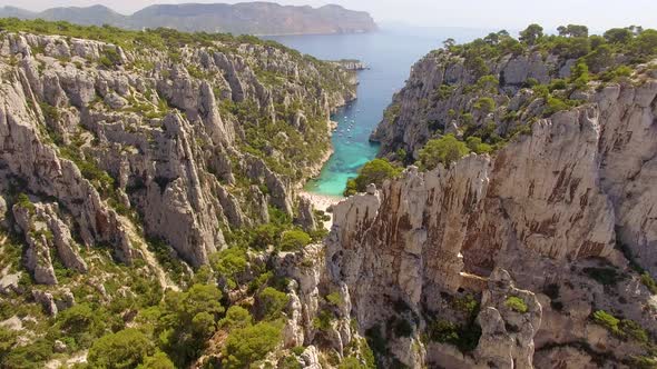 Aerial travel drone view of clear green water, cliffs of Cassis, Mediterranean Sea, Southern France. alt