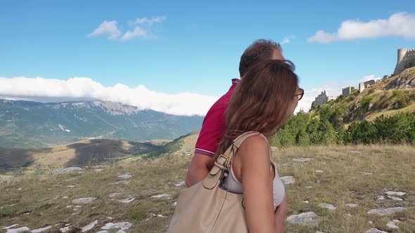 Romantic couple visits Rocca Calascio Abruzzo fortress, near L'Aquila. Italy alt