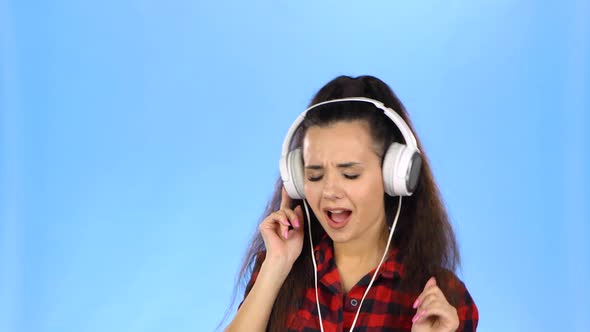 Young Lady Is Listening To Music in Headphones and Dancing alt