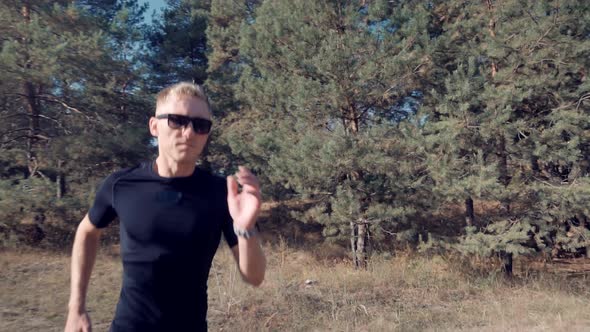 Running Man On Sea Coast Road Half Marathon. Runner Man In Sportswear Preparing To Triathlon. alt