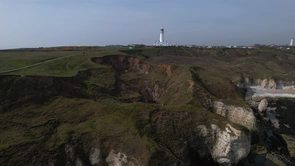 Drone Ascends On White Chalk Cliffs And The Lighthouse At Flamborough, East Riding of Yorkshire. Eng alt