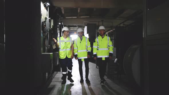 Electrical Engineers in Protective Helmet and Uniform Checking Control Panel Board alt
