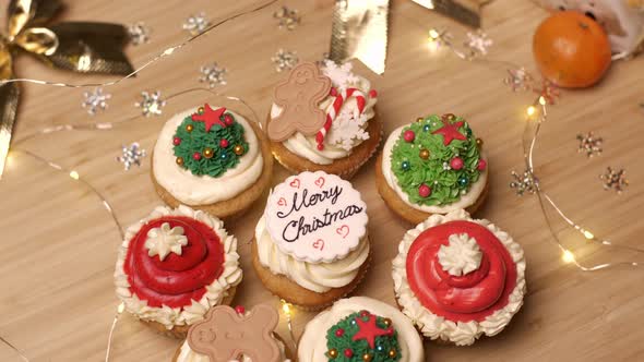 Christmas Decorations and Cupcake on Wooden Background