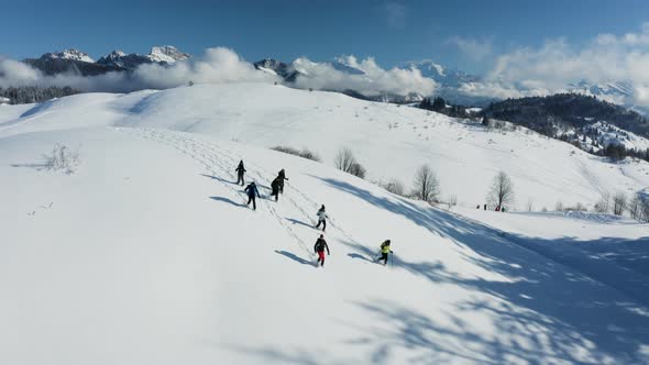 Aerial view of group of friends doing cross country ski in Onnion, France. alt