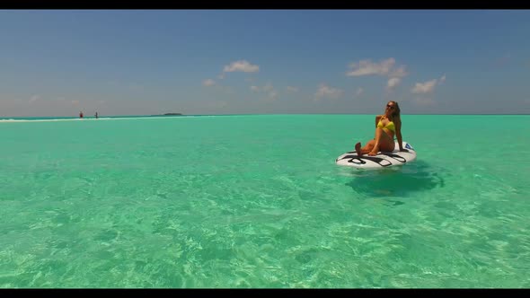 Beautiful ladies happy and smiling on tranquil seashore beach lifestyle by blue green ocean and brig alt