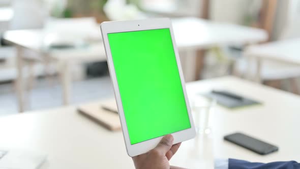 Businessman Watching Tablet with Green Chroma Key Screen alt