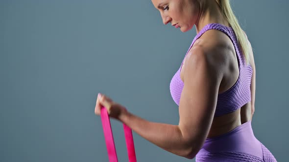 Sporty Woman Doing Exercises Using Rubber Band