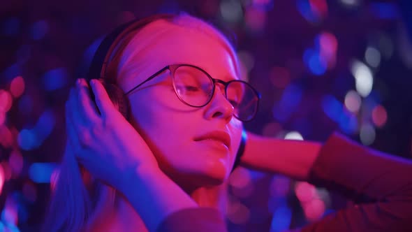 An Energetic Woman Dances to Her Favorite Song in Headphones