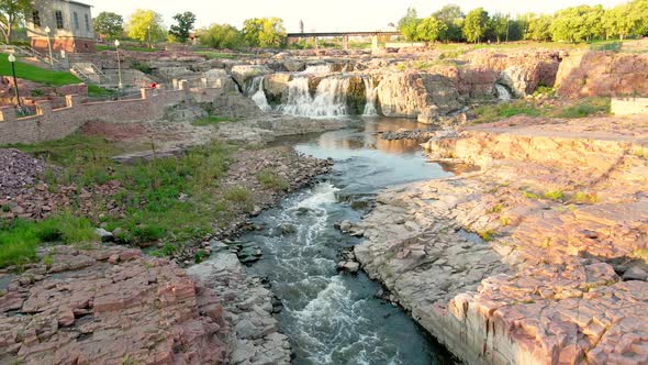 Drone view of Falls Park in Sioux Falls, South Dakota, with observation areas and walking paths.