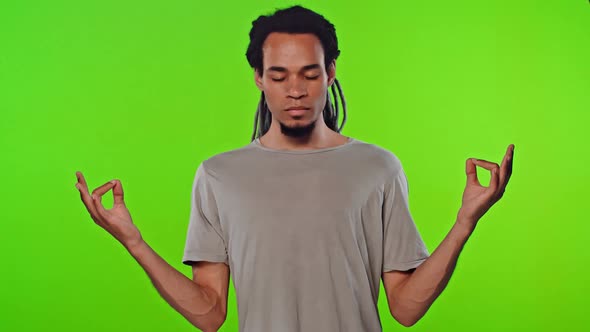 Calm Dark Skinned Man Relaxing Meditating, No Stress Free Relief at Work Concept alt