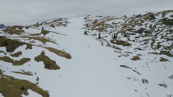 Aerial, Beautiful Winter Landscape In Mountains And Skiers On Ski Tracks In Dolomites In Italy