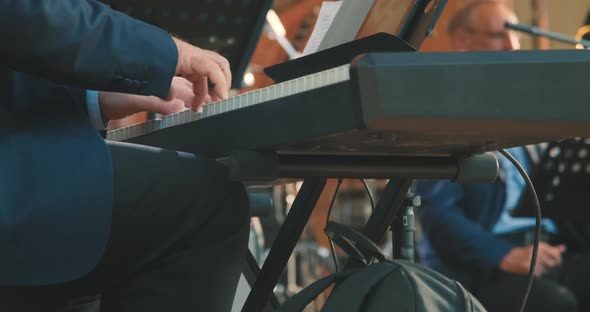 Close Up of Man Hands Playing a Synthesizer at Concert