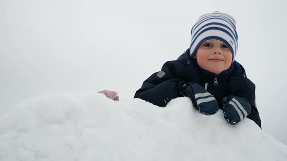 Children Play with Snow Boy and Girl Are Have Fun