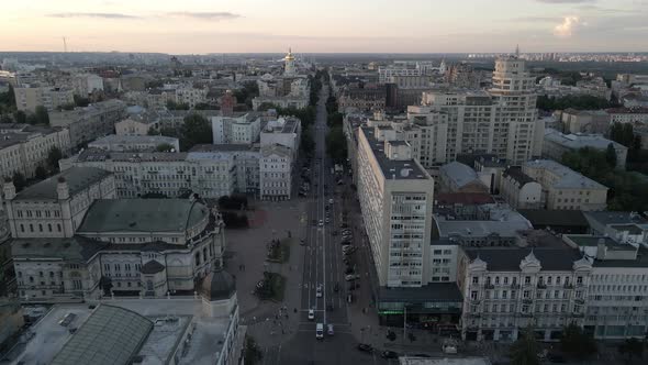 Slow flight over the city center at sunset