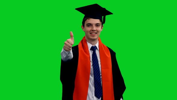 Portrait Of Happy Smiling Graduating Student Showing Thumbs Up Sign