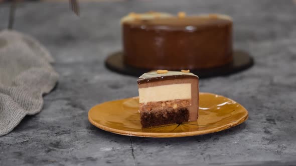 Piece of Chocolate Caramel Peanut Mousse Cake Snickers on a Plate