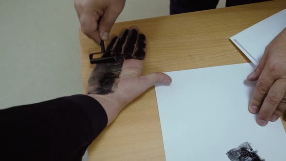 A Man is Being Fingerprinted