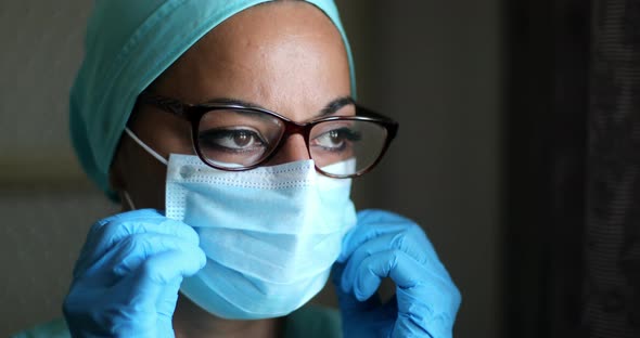 Young female medic, wearing a mask and glasses