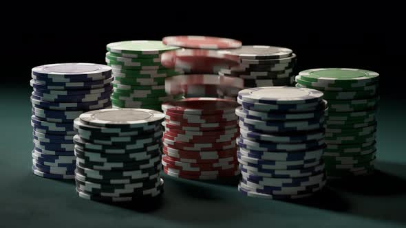 Casino chips or tokens forming stacks on a green gaming table. Jackpot. 4k alt