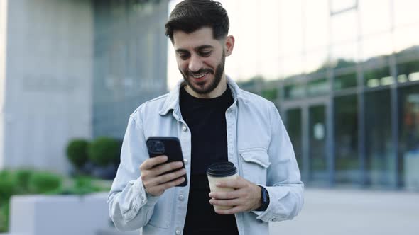 Bearded Man Walking Use Smartphone Look Around at City Center