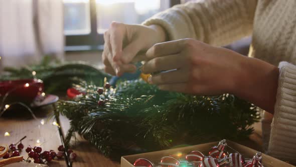Woman Making Fir Christmas Wreath at Home
