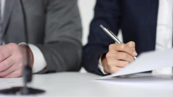 Unrecognizable Business Partners Signing Document alt