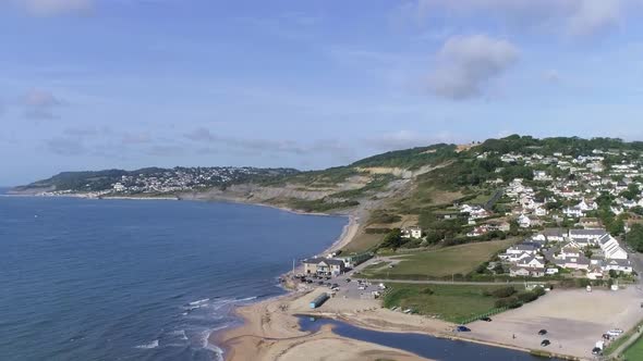 Aerial of Charmouth and the Jurassic coast tracking upward. revealing shot of the vast coastline loo alt