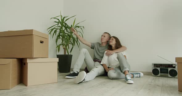 Young Couple on Floor in New Flat