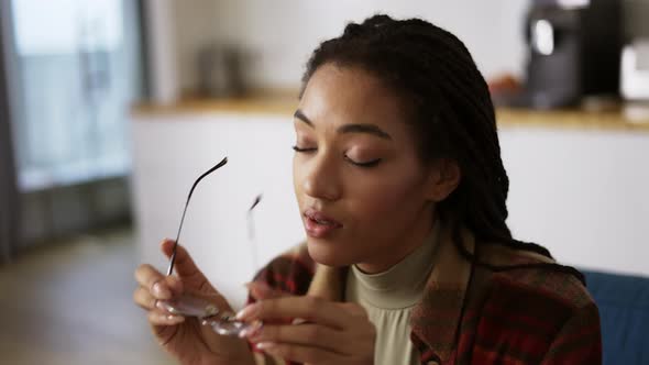 Exhausted African American Woman Putting Off Eyeglasses and Lay Down on Sofa alt