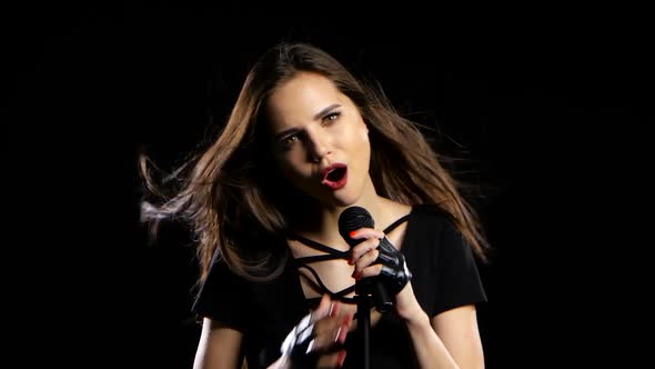 Girl Sings Rocker Songs, She Is Energetic and Sexy. Black Background alt