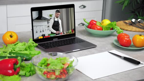 Laptop Computer with Man Food Blogger Tells Teaches Students Slices Tomato alt