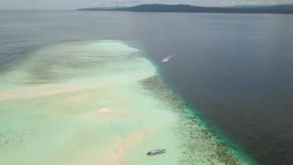 People and Boats on the Sandbank of a Tropical Sea