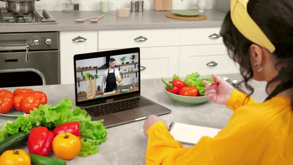 Man Chef Teacher in Laptop Screen Greets Tells Removes Vegetables From Paper Bag alt
