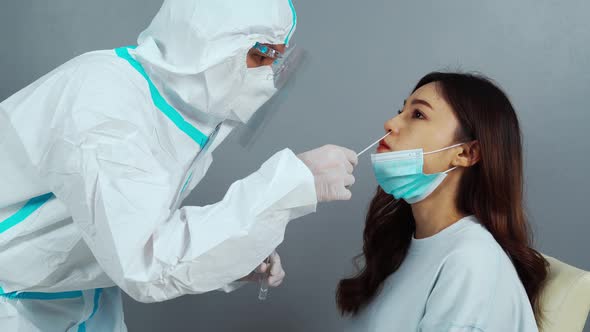doctor with PPE suit test coronavirus(covid-19) to patient by nasal swab alt
