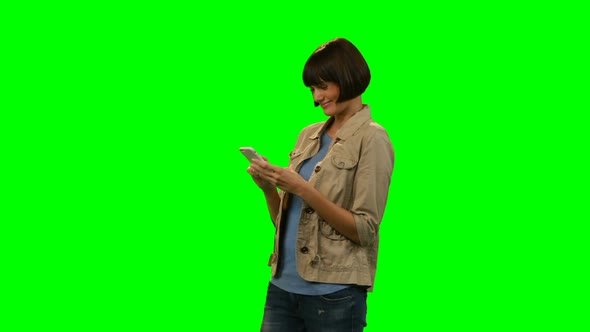 Happy woman using mobile phone alt