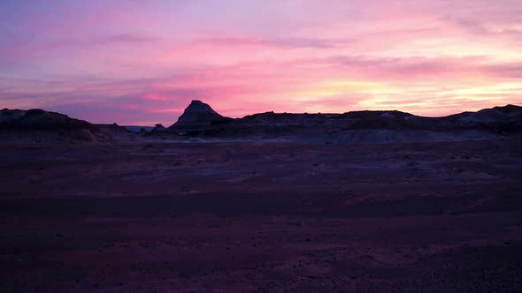 Flying towards colorful sunset in the desert
