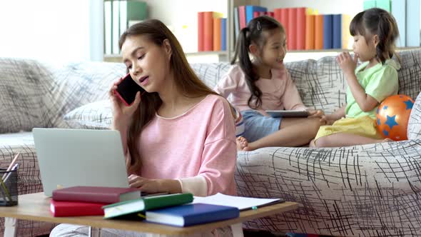 An Asian mother Working From Home With Her Children 04 alt