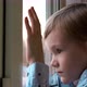 The Little Boy Is Sad At The Window In The Room - VideoHive Item for Sale