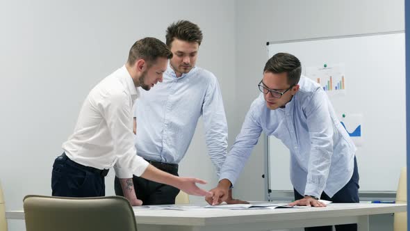 Office Workers Actively Discuss a Project, Come To an Agreement, Look at Graphs and Diagrams