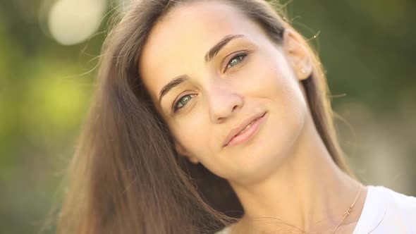 Portrait of Beautiful Woman Smiles and Enjoys of the Moment Isolated on Blur Background